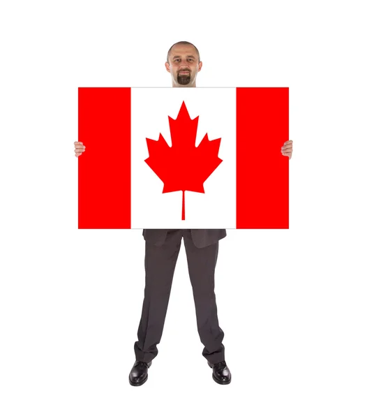 Lachende zakenman met een grote kaart, vlag van canada — Stockfoto