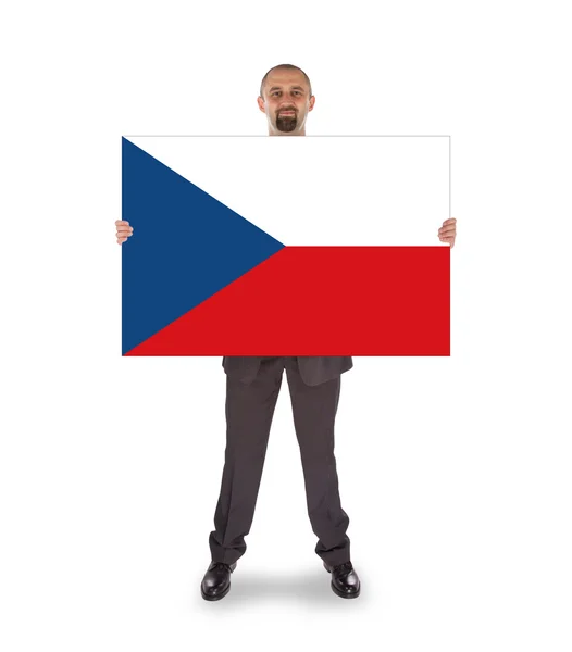 Hombre de negocios sonriente sosteniendo una tarjeta grande, bandera de la República Checa — Foto de Stock