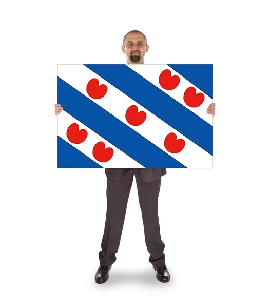 Улыбающийся бизнесмен с большой картой, флаг голландской провинции — стоковое фото