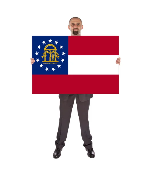 Smiling businessman holding a big card, flag of Georgia — Stock Photo, Image