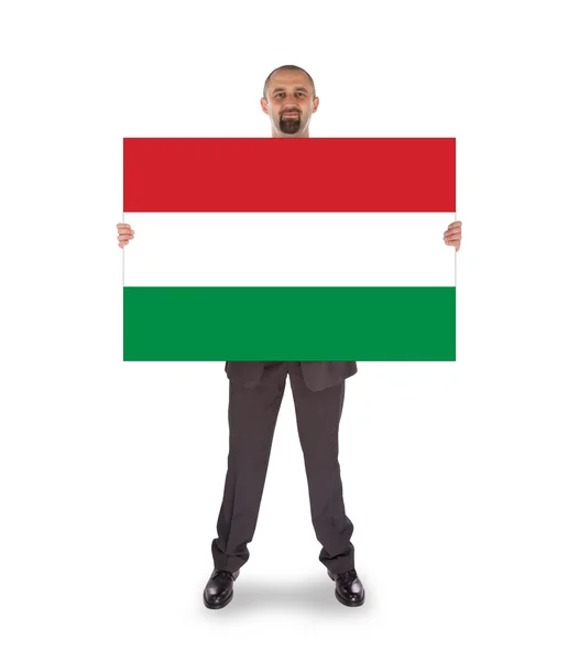 Smiling businessman holding a big card, flag of Hungary — Stock Photo, Image