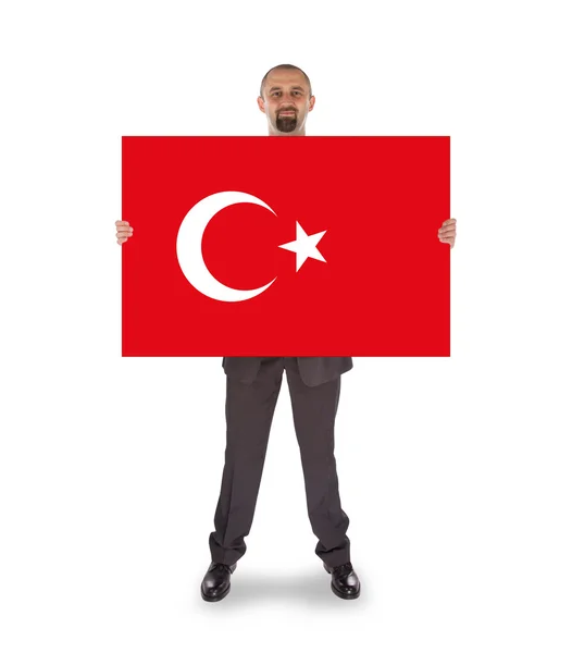 Smiling businessman holding a big card, flag of Turey — Stock Photo, Image