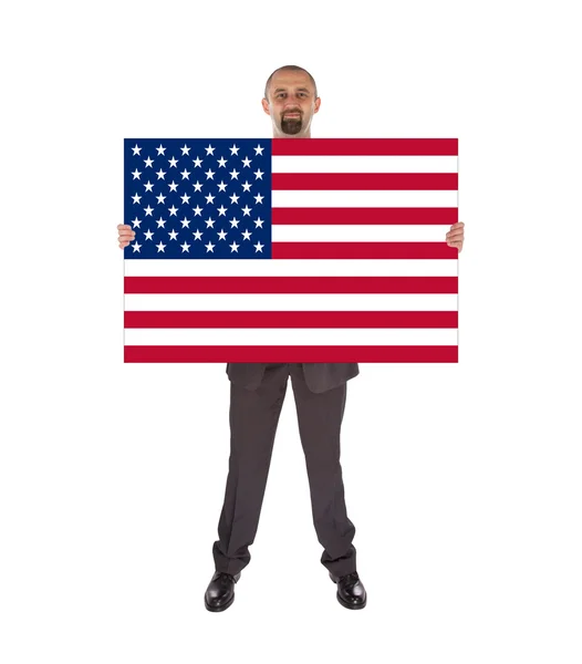Büyük bir kart, Birleşik Devlet bayrağı tutarak gülümseyen iş adamı — Stok fotoğraf