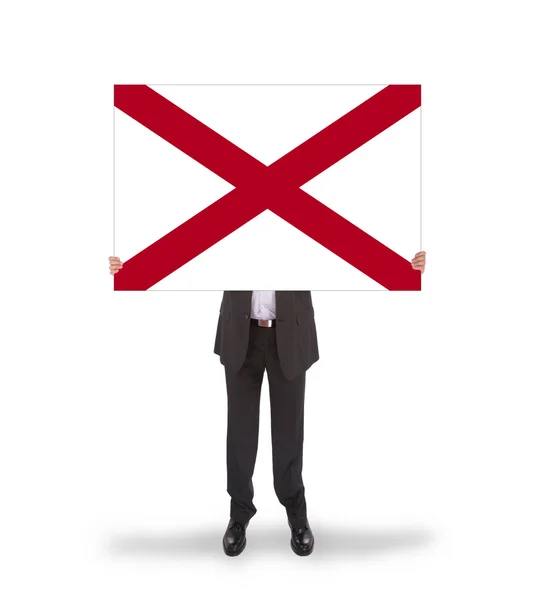 Smiling businessman holding a big card, flag of Alabama — Stock Photo, Image