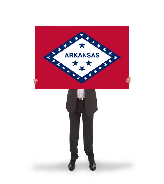 Smiling businessman holding a big card, flag of Arkansas — Stock Photo, Image