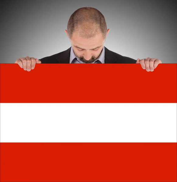 Smiling businessman holding a big card, flag of Austria — Stock Photo, Image