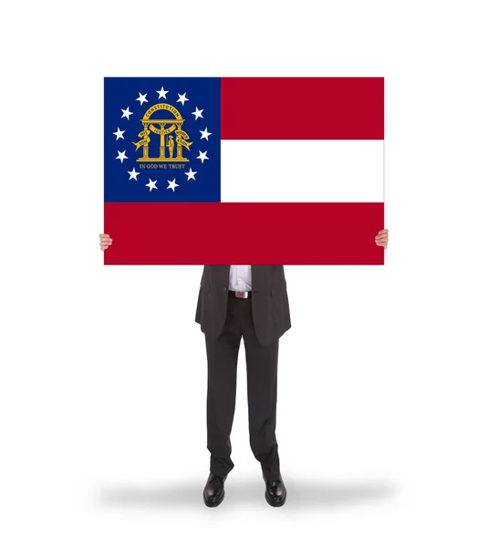 Smiling businessman holding a big card, flag of Georgia — Stock Photo, Image