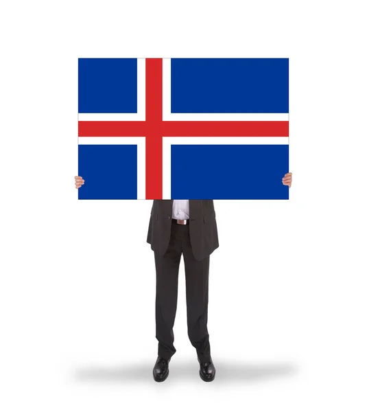 Smiling businessman holding a big card, flag of Iceland — Stock Photo, Image