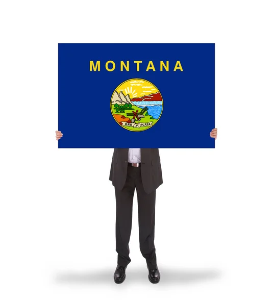 Smiling businessman holding a big card, flag of Montana — Stock Photo, Image