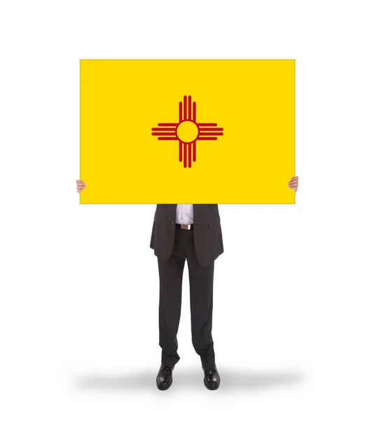 Smiling businessman holding a big card, flag of New Mexico — Stock Photo, Image