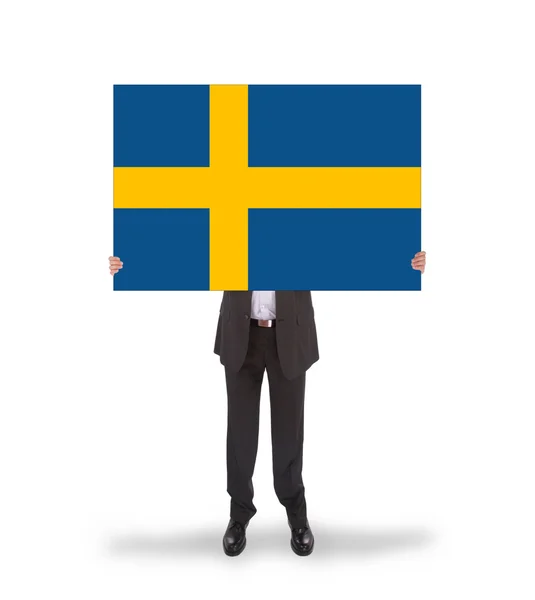 Smiling businessman holding a big card, flag of Sweden — Stock Photo, Image