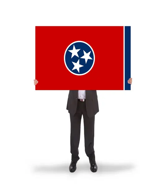 Smiling businessman holding a big card, flag of Tennessee — Stock Photo, Image