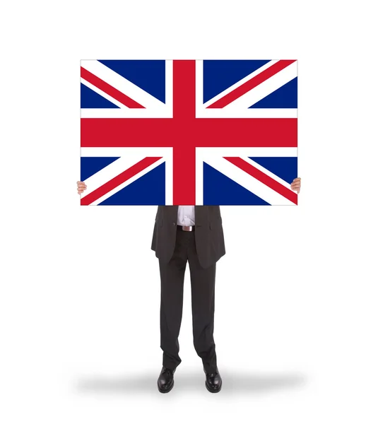Empresário sorridente segurando um cartão grande, bandeira do Reino Unido — Fotografia de Stock