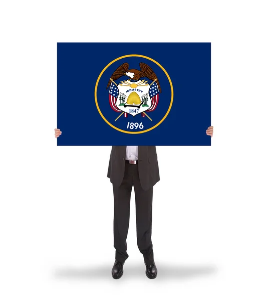 Smiling businessman holding a big card, flag of Utah — Stock Photo, Image