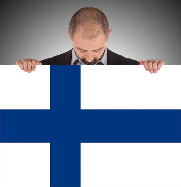 Lachende zakenman met een grote kaart, vlag van finland — Stockfoto