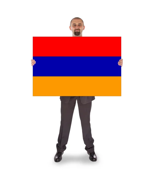 Businessman holding a big card, flag of Armenia — Stock Photo, Image