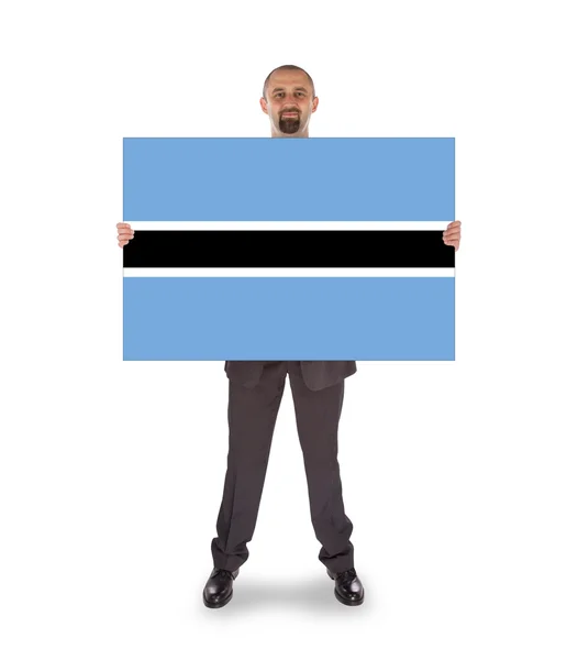 Businessman holding a big card, flag of Botswana — Stock Photo, Image