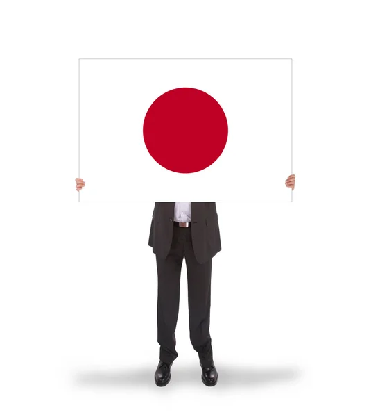 Empresario sosteniendo una gran tarjeta, bandera de Japón —  Fotos de Stock