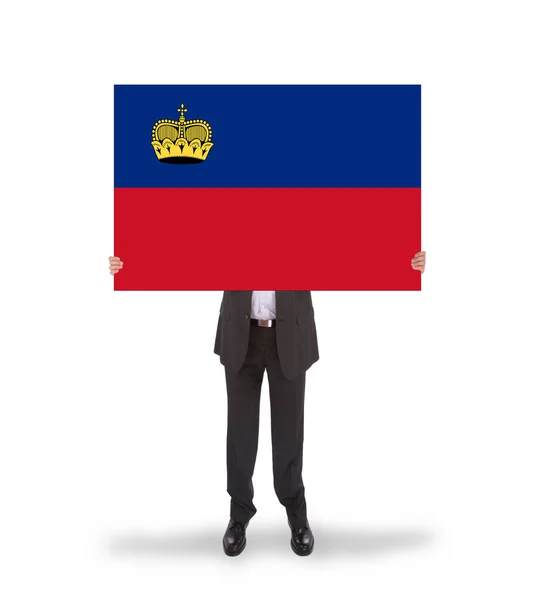 Zakenman met een grote kaart, vlag van liechtenstein — Stockfoto