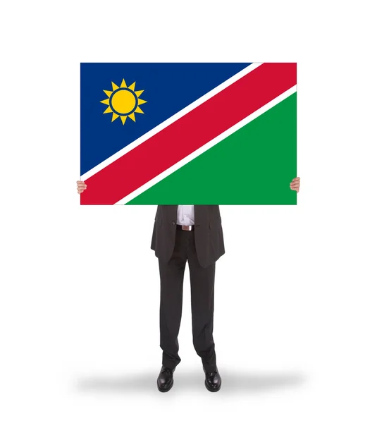 Affärsman som innehar ett stort kort, flagga namibia — Stockfoto