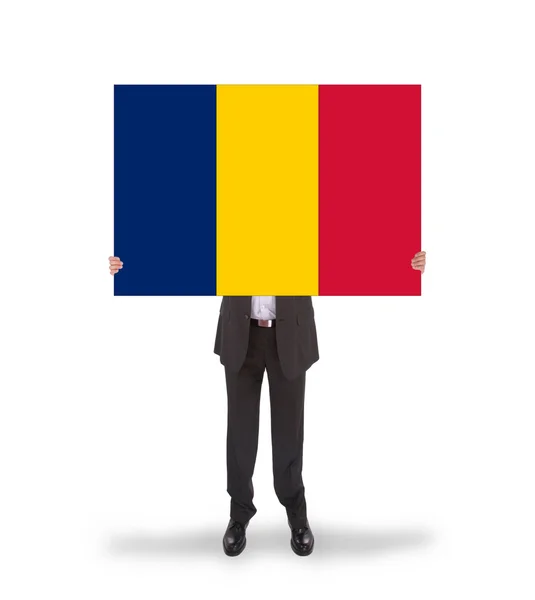 นักธุรกิจถือบัตรใหญ่ ธงโรมาเนีย — ภาพถ่ายสต็อก