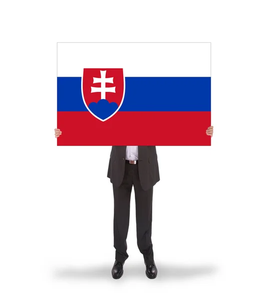 Empresário segurando um cartão grande, bandeira da Eslováquia — Fotografia de Stock