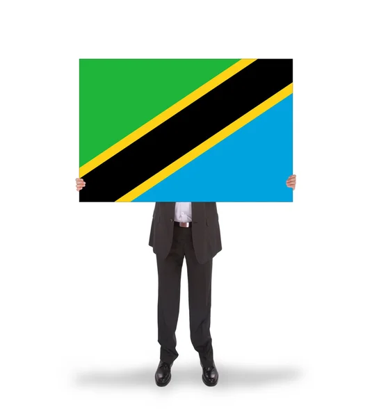 Homme d'affaires tenant une grande carte, drapeau de Tanzanie — Photo