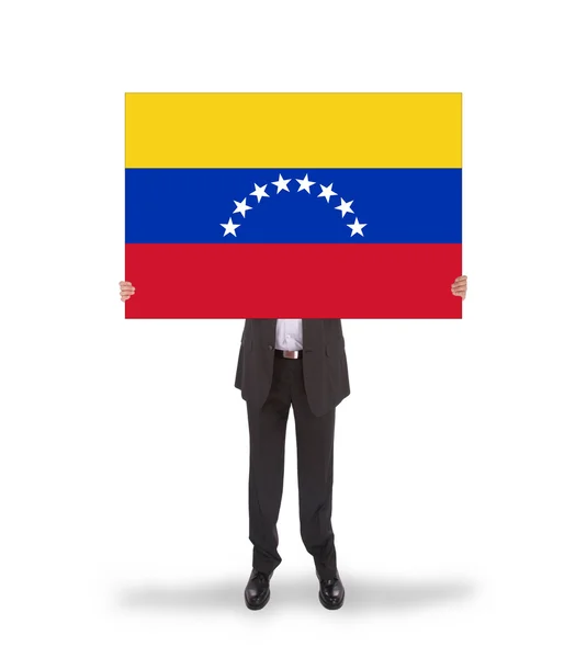 Empresario sosteniendo una gran tarjeta, bandera de Venezuela —  Fotos de Stock