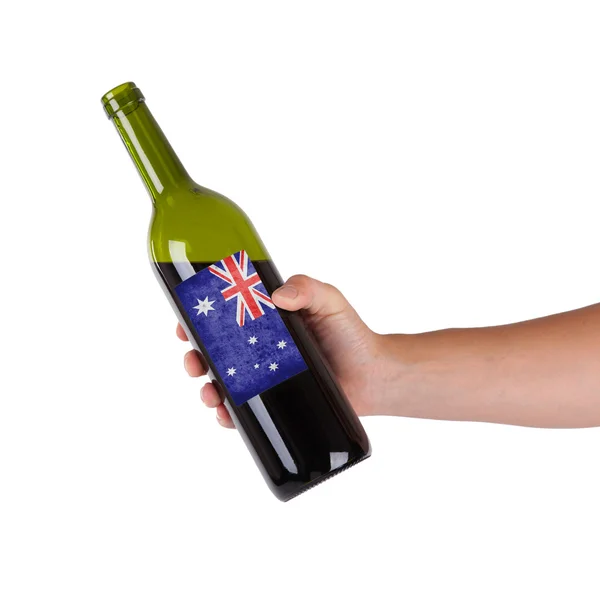 Hand holding a bottle of red wine — Stock Photo, Image