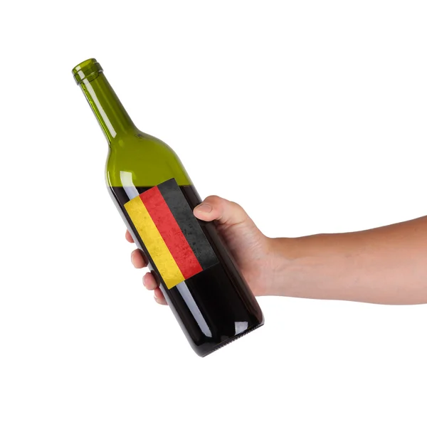 Hand hält eine Flasche Rotwein — Stockfoto