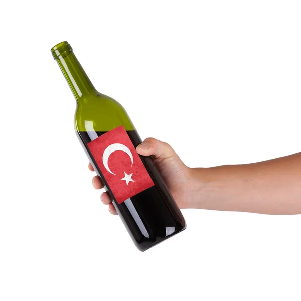 Hand holding a bottle of red wine — Stock Photo, Image