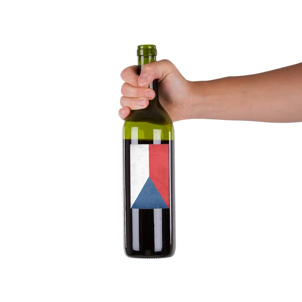 Mano sosteniendo una botella de vino tinto — Foto de Stock