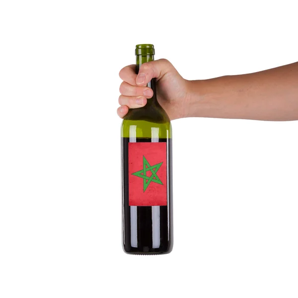 Hand holding a bottle of red wine — Stock Photo, Image