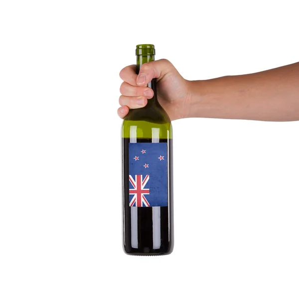 Рука тримає пляшку червоного вина — стокове фото