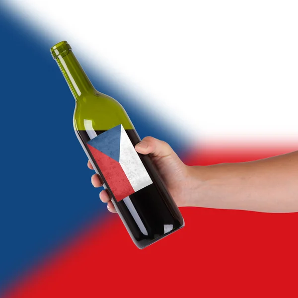 Hand holding a bottle of red wine — Stock Photo, Image