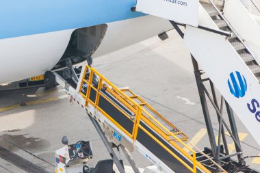 AMSTERDAM - SEPTEMBER 6: KLM plane is being loaded at Schiphol A clipart