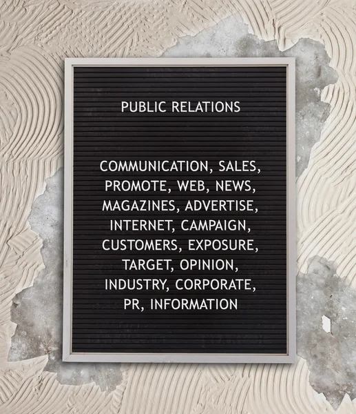 Public relations concept in plastic letters on very old menu boa — Stock Photo, Image