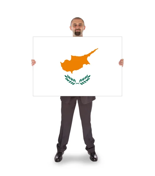 Smiling businessman holding a big card or flag — Stock Photo, Image