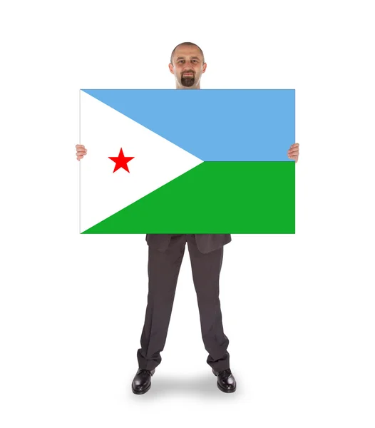 Smiling businessman holding a big card or flag — Stock Photo, Image