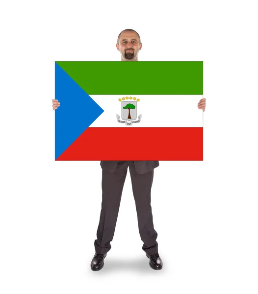 Smiling businessman holding a big card or flag — Stock Photo, Image