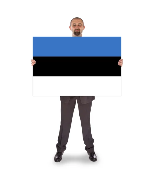Smiling businessman holding a big card or flag — Stock Photo, Image