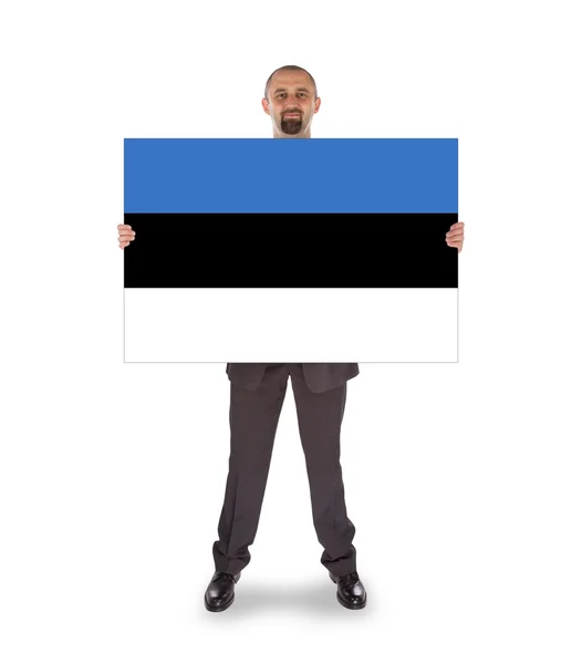 Lachende zakenman bezit is van een grote kaart of vlag — Stockfoto