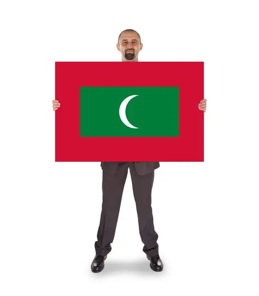 Uomo d'affari sorridente in possesso di una grande carta o bandiera — Foto Stock