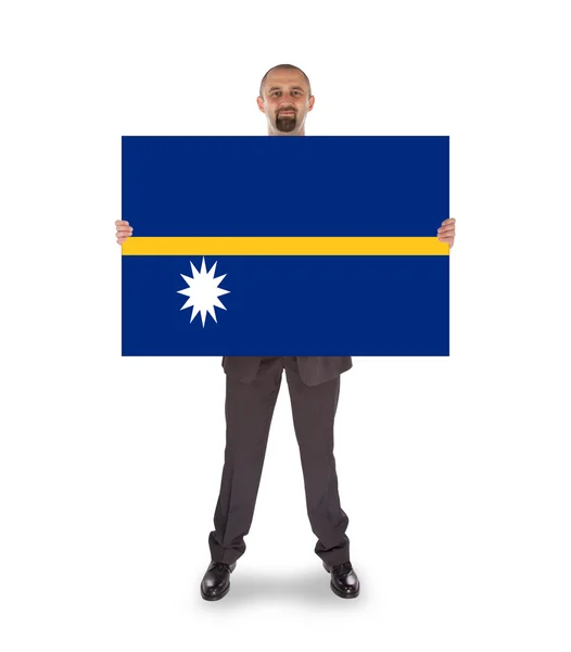 Улыбающийся бизнесмен с большой картой или флагом — стоковое фото