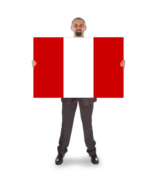 Smiling businessman holding a big card or flag — Stock Photo, Image