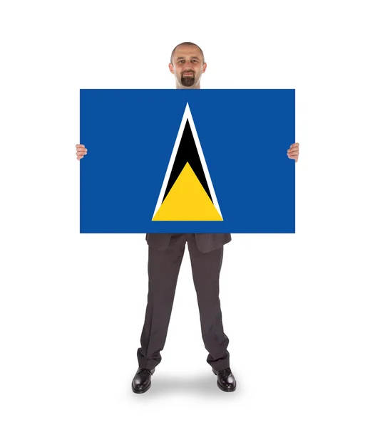 Smiling businessman holding a big card or flag — Stock Photo, Image