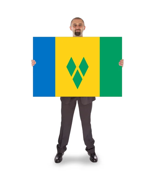 Empresário sorridente segurando um cartão grande ou bandeira — Fotografia de Stock