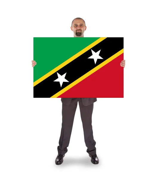 Homme d'affaires souriant tenant une grande carte ou un drapeau — Photo