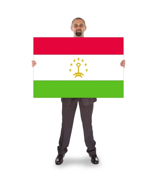 Smiling businessman holding a big card or flag — Stock Photo, Image