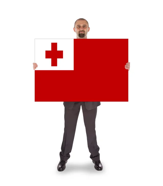 Smiling businessman holding a big card or flag — Stock Photo, Image